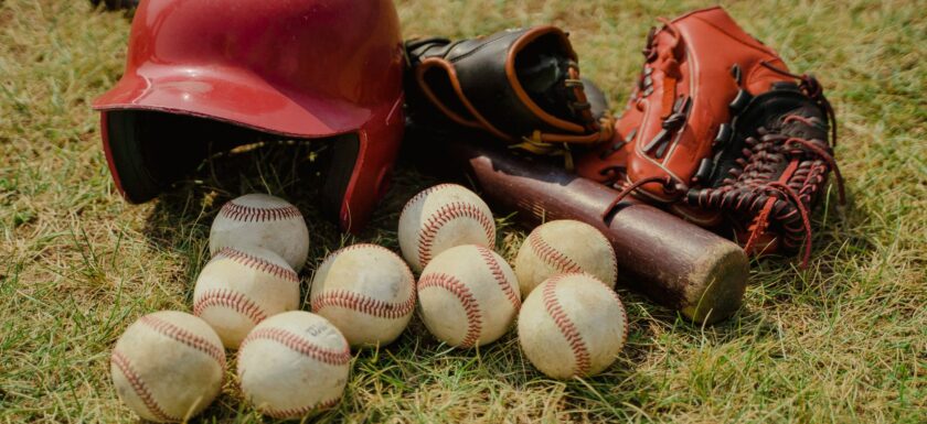 red baseball helmet on green grass field