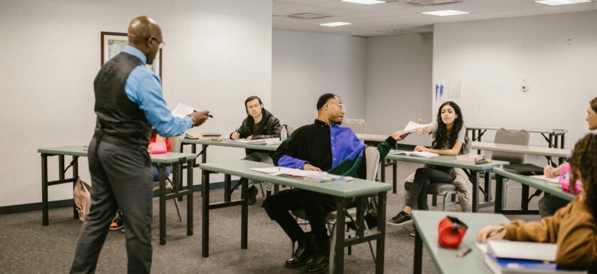 teacher giving the test results to his students